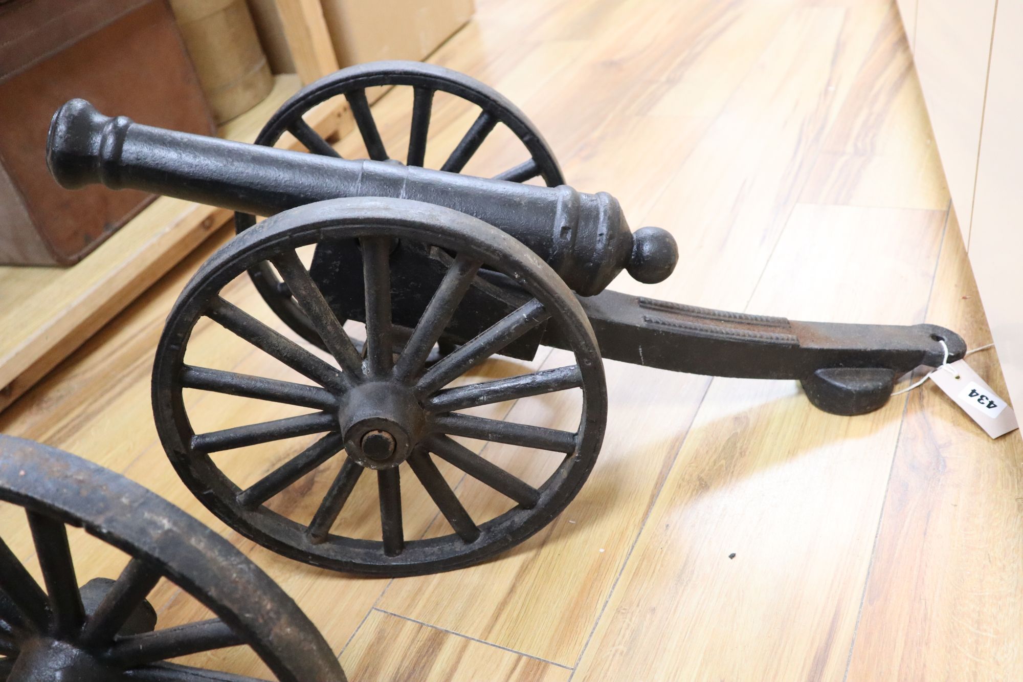 A pair of cast iron models of cannons, length 71cm